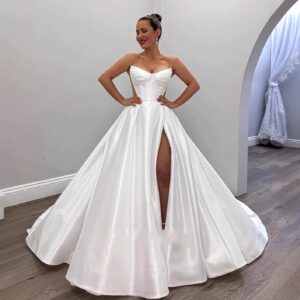 minimalist-strapless-satin-a-line-wedding-dress-corset-bodice-sweetheart-neck-illusion-side-panels-high-slit-chapel-train-bridal-gown