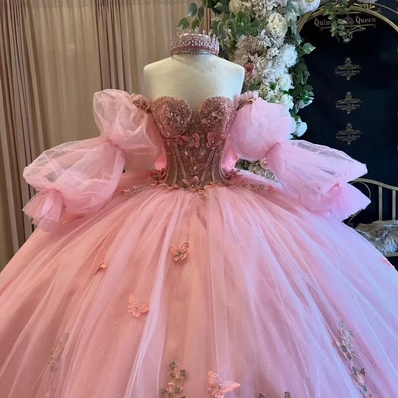 pink-butterfly-applique-quinceanera-ball-gown-with-beaded-sheer-corset-sweetheart-bodice-detachable-puff-sleeves-and-full-tulle-skirt