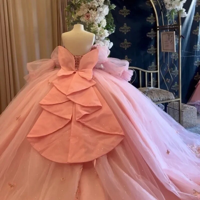 pink-oversized-back-bow-quinceanera-ball-gown-with-lace-up-corset-glitter-tulle-skirt-butterfly-applique-and-chapel-train